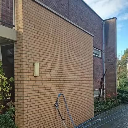 Dezelfde bakstenen gevel weer egaal van kleur na de reiniging